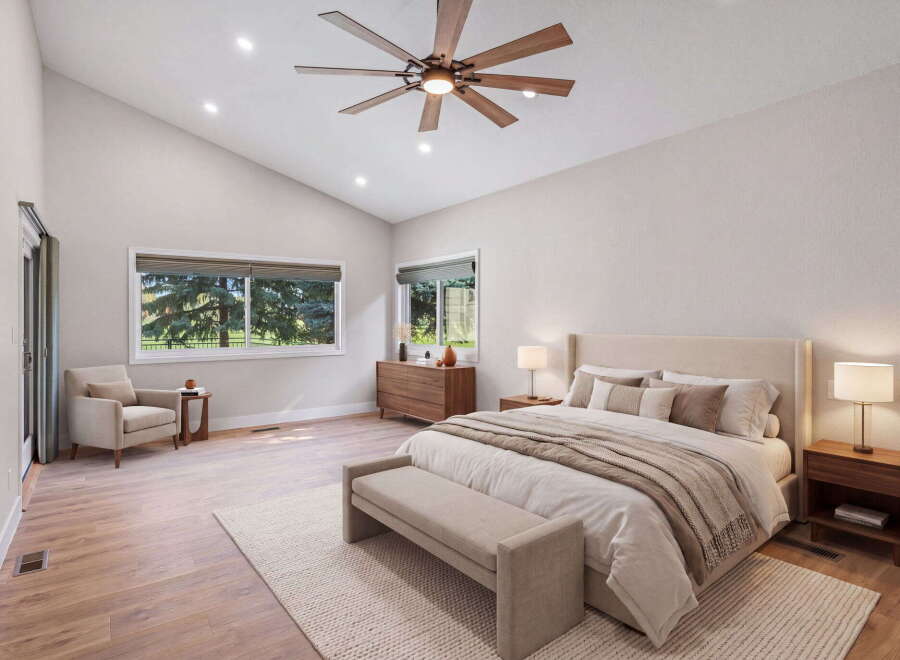 Experience luxury and comfort in this stunning bedroom, featuring a vaulted ceiling with a modern fan and recessed lighting.