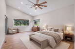 Experience luxury and comfort in this stunning bedroom, featuring a vaulted ceiling with a modern fan and recessed lighting.