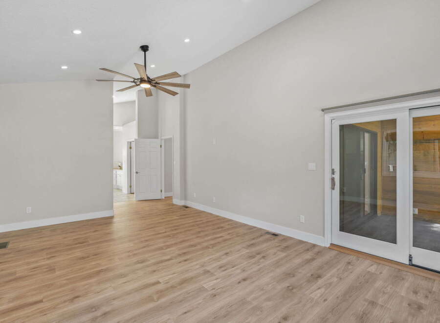 Experience spacious living in this modern home featuring a vaulted ceiling and a stylish ceiling fan.