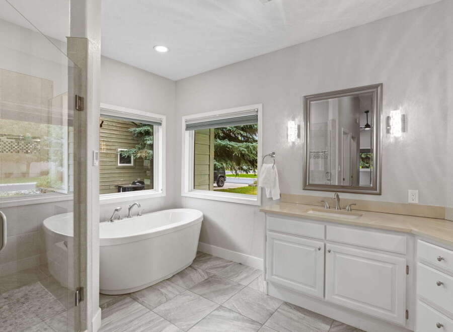 Indulge in luxury with this stunning bathroom featuring a freestanding soaking tub and a spacious walk-in shower.
