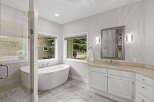 Indulge in luxury with this stunning bathroom featuring a freestanding soaking tub and a spacious walk-in shower.
