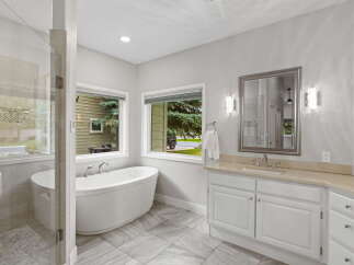 Indulge in luxury with this stunning bathroom featuring a freestanding soaking tub and a spacious walk-in shower.