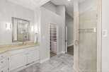 Experience luxury in this spacious bathroom featuring a large vanity with ample counter space and a sleek undermount sink.