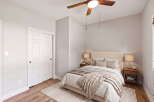 Discover this inviting bedroom featuring a plush bed adorned with neutral-toned linens and a cozy throw blanket.