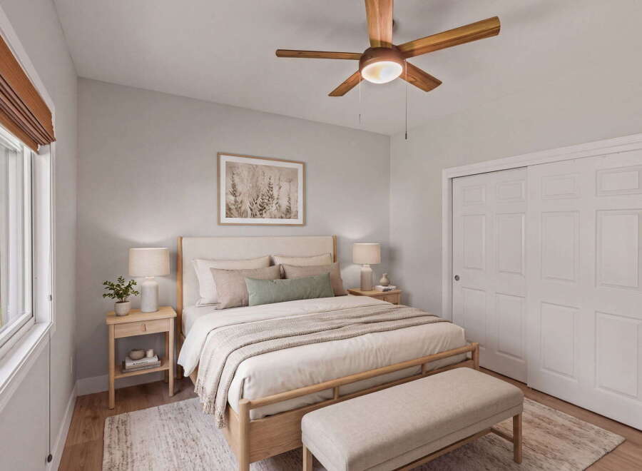 Experience serene comfort in this beautifully appointed bedroom, featuring a plush king-sized bed adorned with soft, neutral linens and accent pillows.