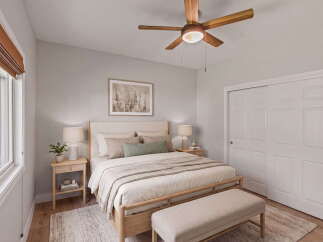 Experience serene comfort in this beautifully appointed bedroom, featuring a plush king-sized bed adorned with soft, neutral linens and accent pillows.