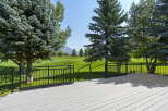 Enjoy breathtaking views from this expansive deck overlooking a pristine golf course.