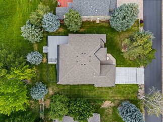 Discover this stunning property from an aerial perspective, showcasing a beautifully maintained home with a spacious deck perfect for outdoor living.