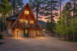 Experience the charm of this A-frame cabin nestled among tall pines, perfect for a mountain getaway.