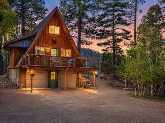 Experience the charm of this A-frame cabin nestled among tall pines, perfect for a mountain getaway.