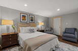 Experience cozy comfort in this charming bedroom, featuring a rustic wooden headboard and plush bedding.