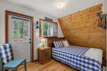 Cozy bedroom featuring a comfortable bed with blue and white gingham bedding and a matching throw pillow.