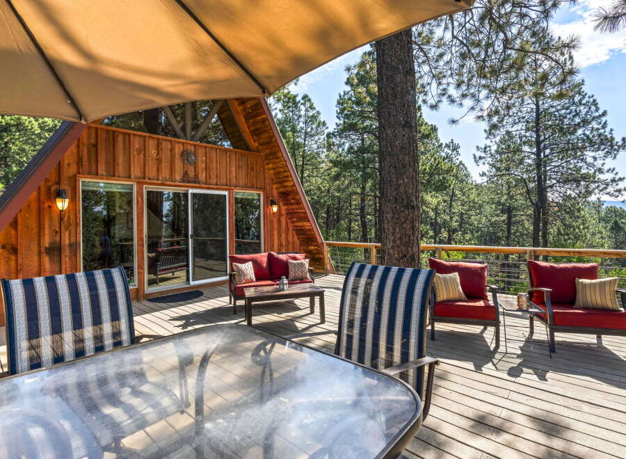 Enjoy breathtaking mountain views from this stunning A-frame cabin's expansive deck, perfect for outdoor entertaining.