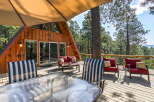 Enjoy breathtaking mountain views from this stunning A-frame cabin's expansive deck, perfect for outdoor entertaining.