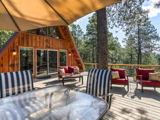 Enjoy breathtaking mountain views from this stunning A-frame cabin's expansive deck, perfect for outdoor entertaining.