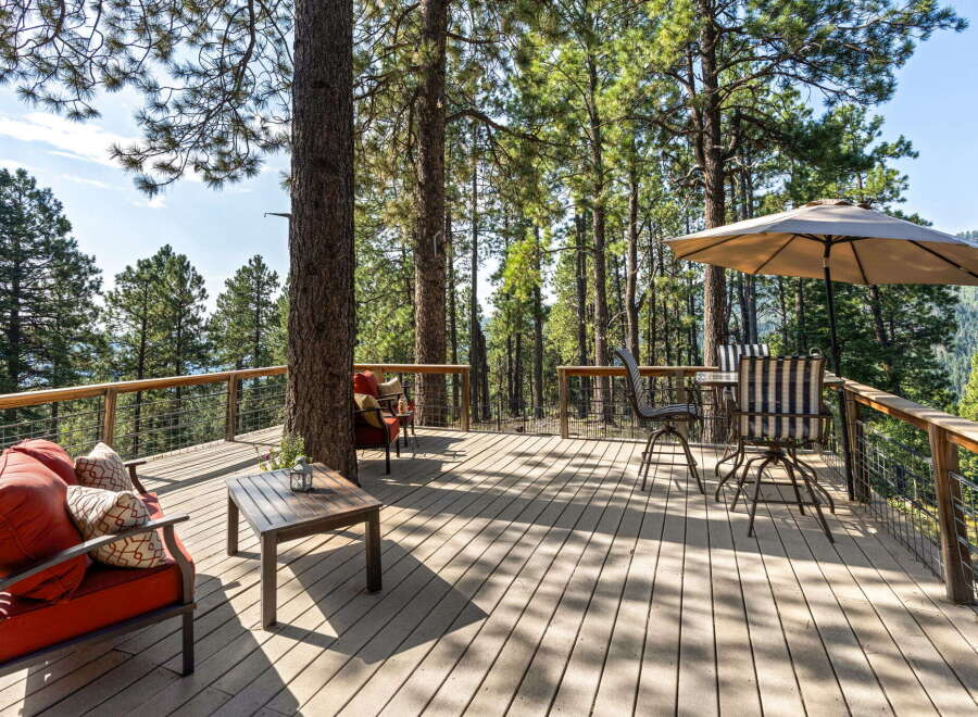 Enjoy breathtaking mountain views from this expansive wooden deck, perfect for outdoor entertaining or quiet relaxation.