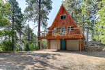 Experience mountain living in this charming A-frame cabin nestled amongst tall pine trees.