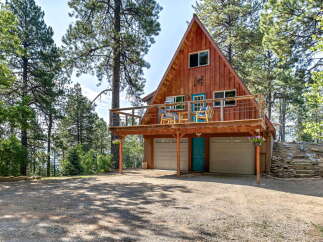 Experience mountain living in this charming A-frame cabin nestled amongst tall pine trees.
