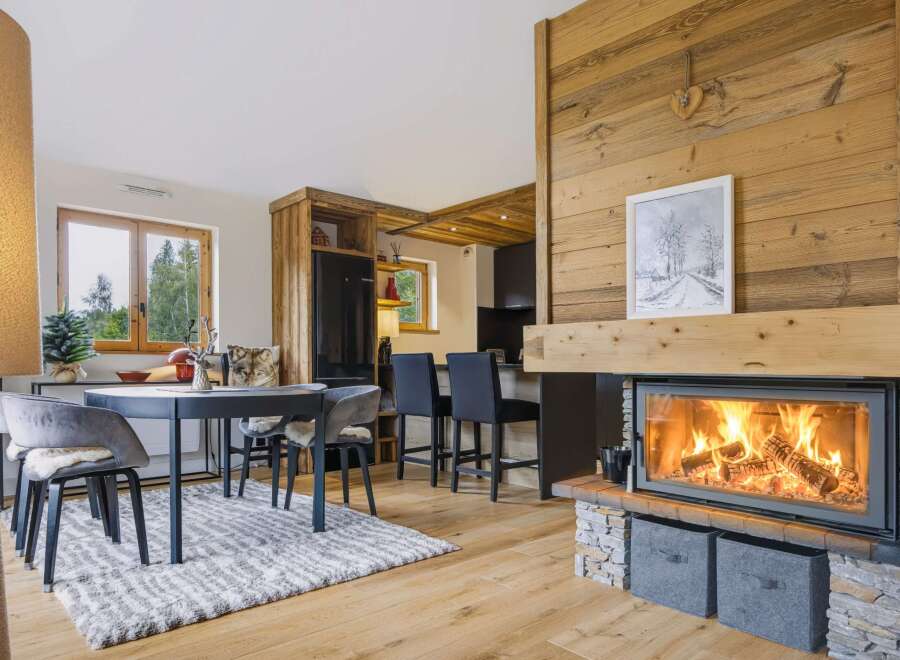 Experience cozy living in this charming mountain retreat, featuring a stunning wood-burning fireplace as the centerpiece of the open-concept living area.