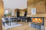 Experience cozy living in this charming mountain retreat, featuring a stunning wood-burning fireplace as the centerpiece of the open-concept living area.