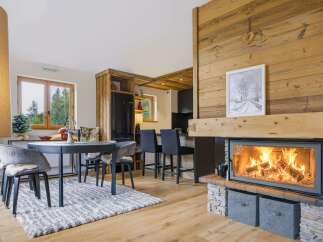 Experience cozy living in this charming mountain retreat, featuring a stunning wood-burning fireplace as the centerpiece of the open-concept living area.