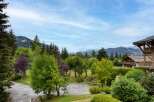 Experience the charm of alpine living with this stunning property nestled amidst lush greenery and majestic mountains.