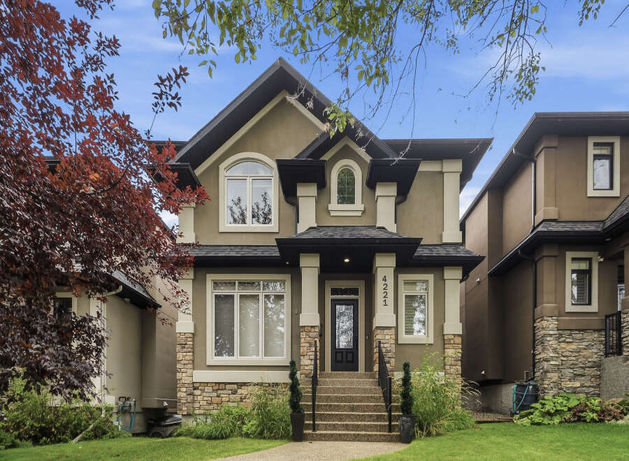 Discover this stunning two-story home featuring a modern stucco exterior with stone accents and a welcoming covered porch.