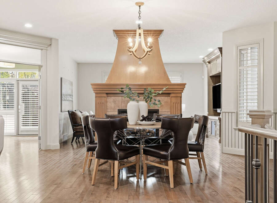 Experience elegant dining in this beautifully appointed space, featuring a round dining table with plush leather chairs perfect for hosting.