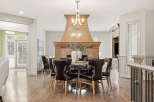 Experience elegant dining in this beautifully appointed space, featuring a round dining table with plush leather chairs perfect for hosting.