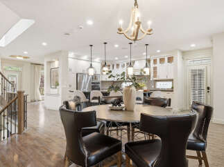 Experience elegant open-concept living with this stunning dining area and gourmet kitchen.