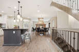 Experience luxury living in this stunning open-concept home, featuring a gourmet kitchen with a large island and pendant lighting, perfect for entertaining.
