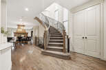 Step into this stunning home featuring a grand curved staircase with elegant wrought-iron railings, perfect for making a statement.
