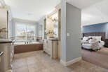 Experience luxury in this master suite featuring a spa-like bathroom with a soaking tub and dual vanities.