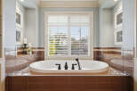 Indulge in relaxation in this luxurious bathroom, featuring a deep soaking tub perfect for unwinding.