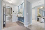 Step into this elegant hallway featuring a striking blue accent wall adorned with a decorative mirror and console table.
