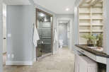 Experience luxury in this spacious bathroom featuring a stunning glass-enclosed shower with modern tile work.