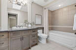 This beautifully appointed bathroom features a spacious vanity with ample storage and a sleek granite countertop.
