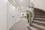 This elegant home features a stunning curved staircase with a wrought-iron railing, leading to the upper levels.