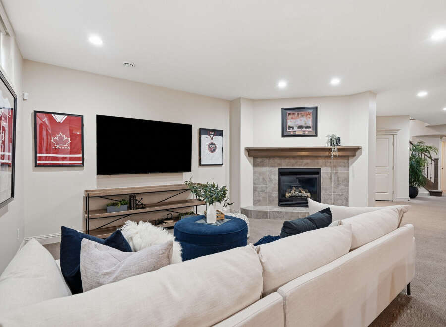 This inviting living room features a cozy fireplace with a tiled surround and a wooden mantel, perfect for gathering.