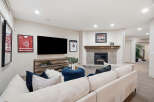 This inviting living room features a cozy fireplace with a tiled surround and a wooden mantel, perfect for gathering.