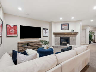 This inviting living room features a cozy fireplace with a tiled surround and a wooden mantel, perfect for gathering.