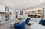 This inviting basement living area features a cozy fireplace with a tile surround, perfect for relaxing evenings.