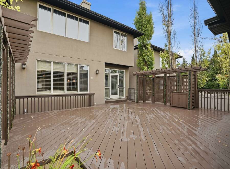 Step outside to a spacious, multi-level deck perfect for entertaining, featuring a charming pergola with built-in seating and storage.