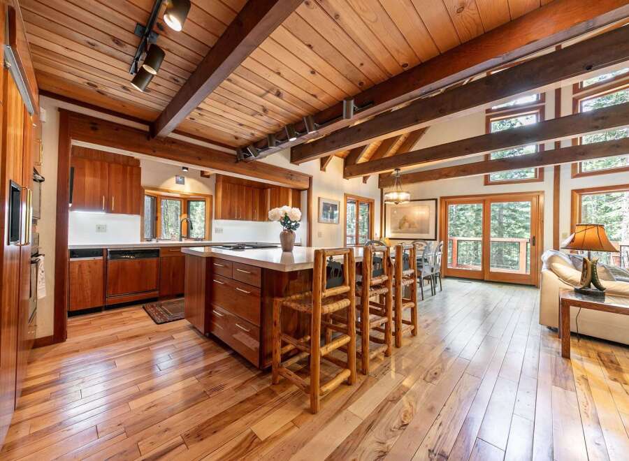 Experience rustic charm in this spacious kitchen featuring rich wood cabinetry and a large island perfect for entertaining.