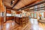 Experience rustic charm in this spacious kitchen featuring rich wood cabinetry and a large island perfect for entertaining.