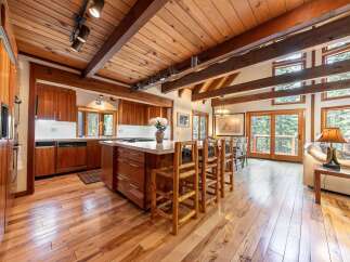 Experience rustic charm in this spacious kitchen featuring rich wood cabinetry and a large island perfect for entertaining.