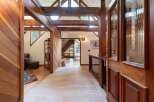 Step into a warm and inviting entryway featuring rich wood paneling and exposed beams that create a cozy, rustic ambiance.