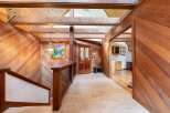 Step into a warm and inviting entryway featuring rich wood paneling and exposed beams, creating a rustic yet elegant ambiance.