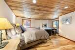 Experience ultimate comfort in this inviting bedroom, featuring a plush bed adorned with decorative pillows and a cozy duvet.