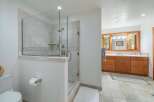 Experience luxury in this spacious bathroom featuring a modern glass-enclosed shower with elegant tilework.